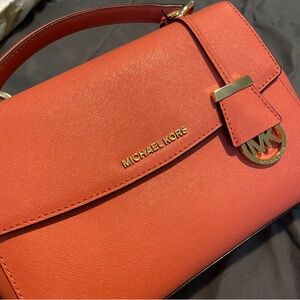 Michael Kors handbag very light weight no stains , no scratches never used